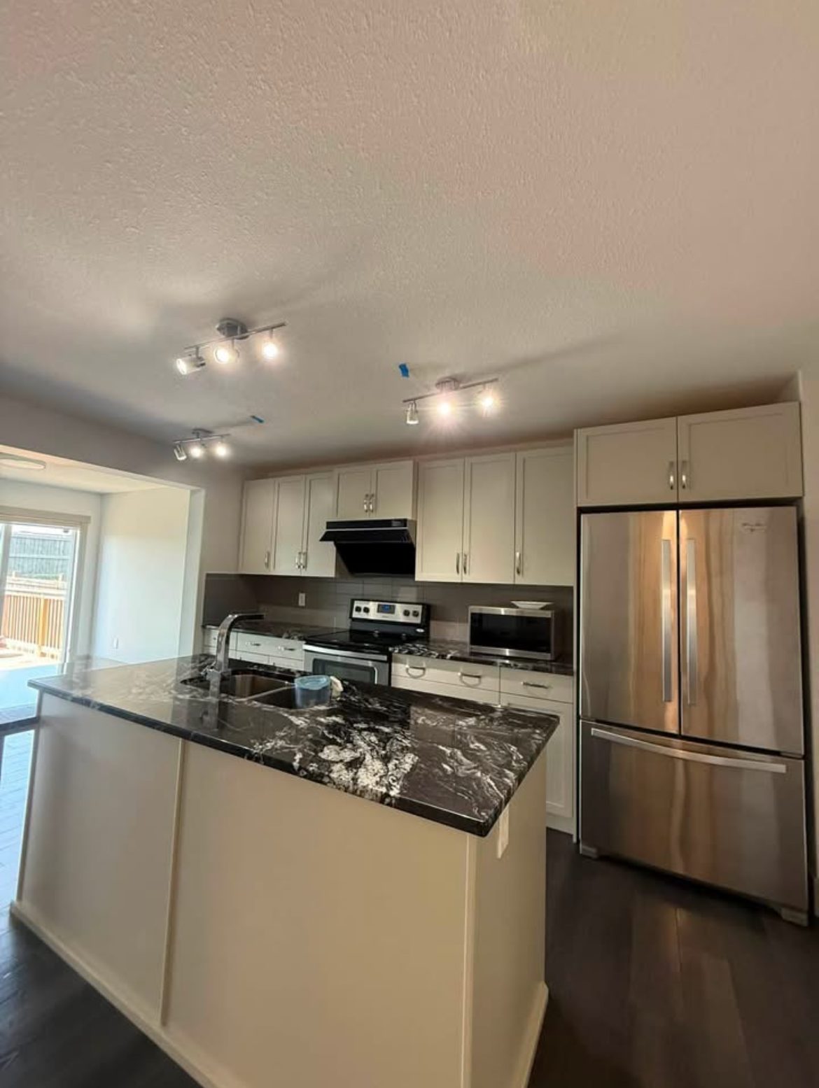 A recently cleaned kitchen with stainless appliances